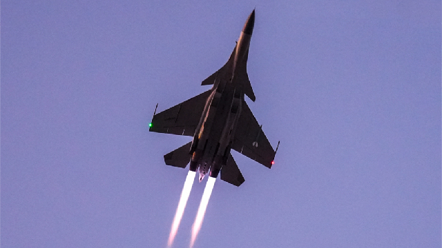 Fighter jet soars into sky at night